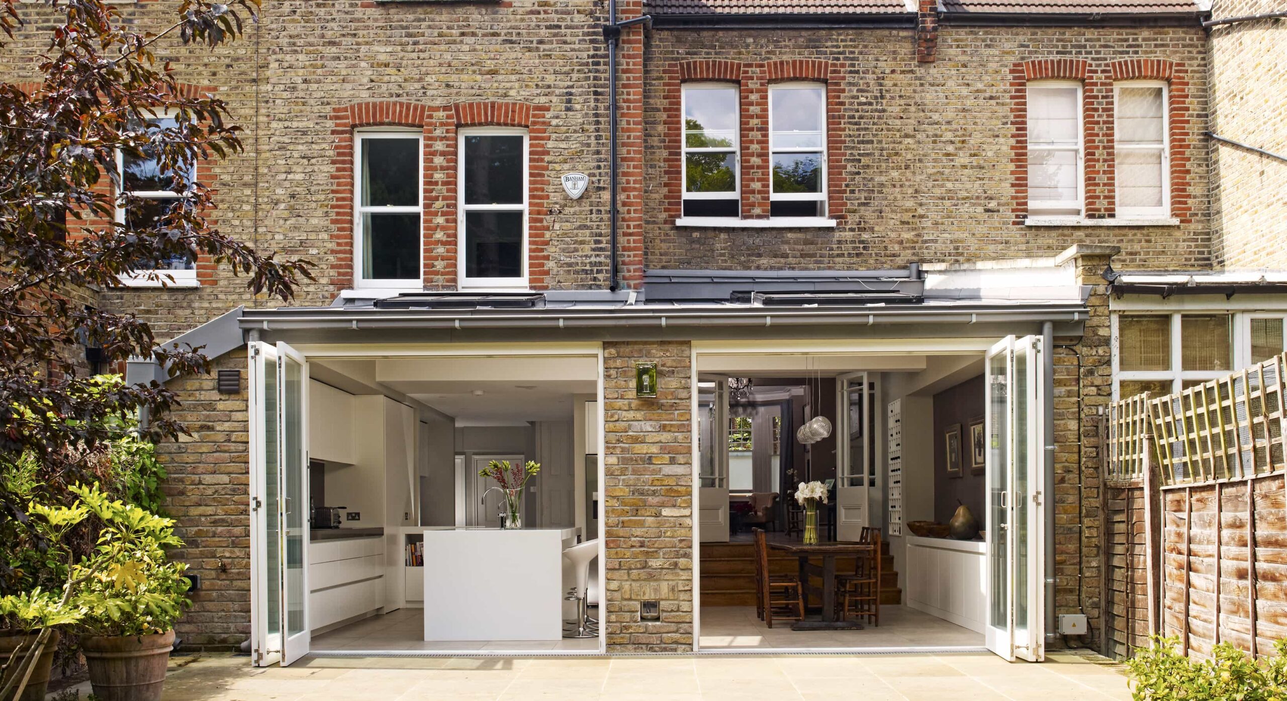 Exterior of the Esmund kitchen extension with by-fold doors open